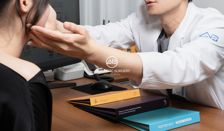 Plastic surgery consultation in Korea showing a doctor assessing skin condition before creating an individualized treatment plan